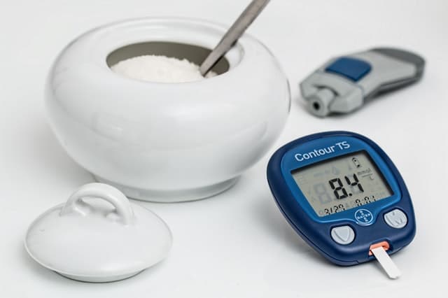 bowl of sugar and blood glucose reader