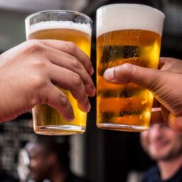 People holding pints of beer 