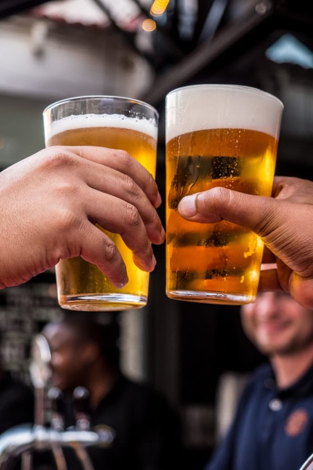 People holding pints of beer