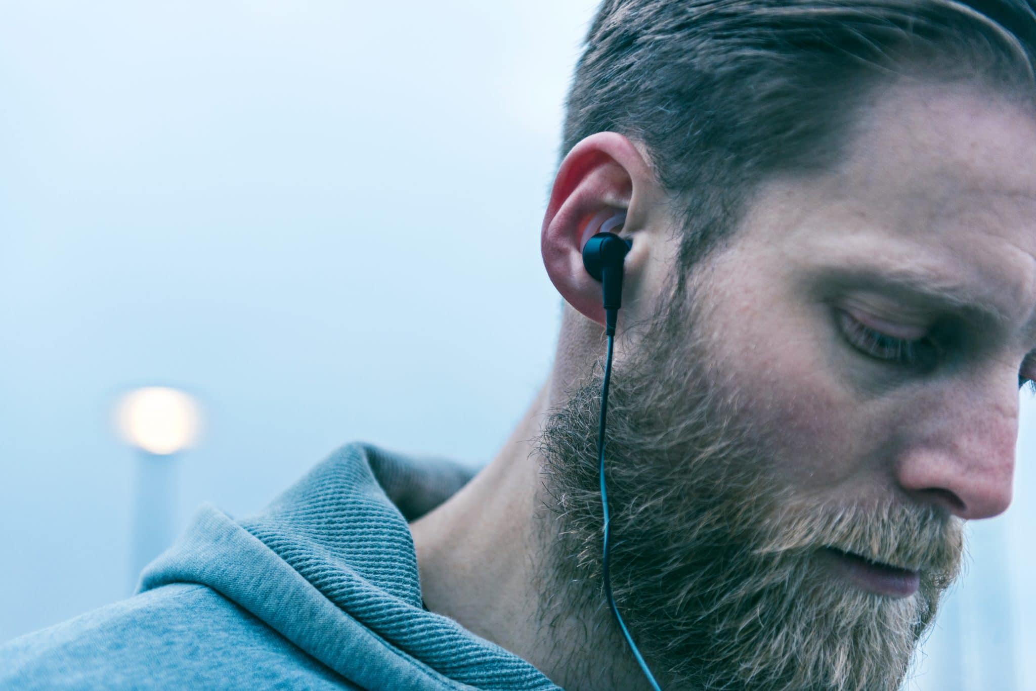 man wearing black ear buds