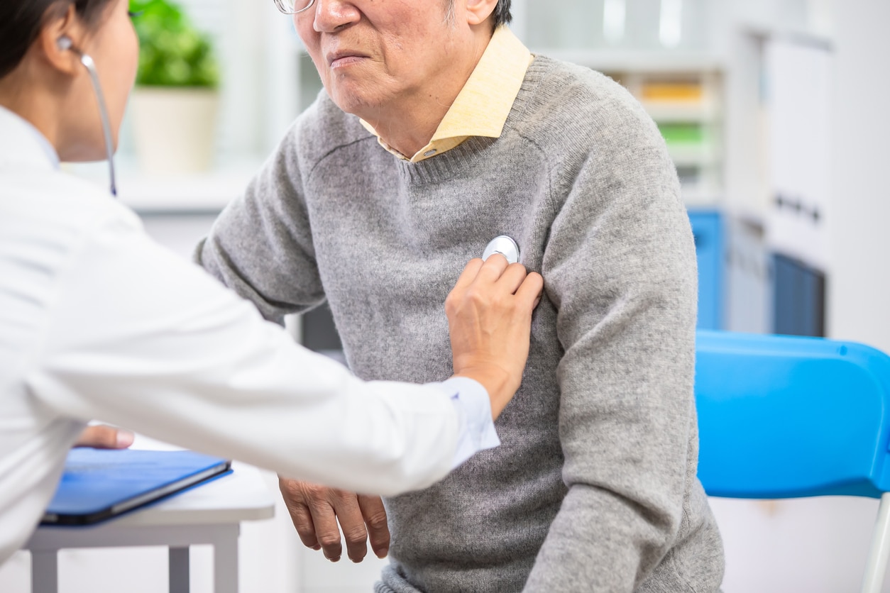 doctor with a stethoscope on a mans chest