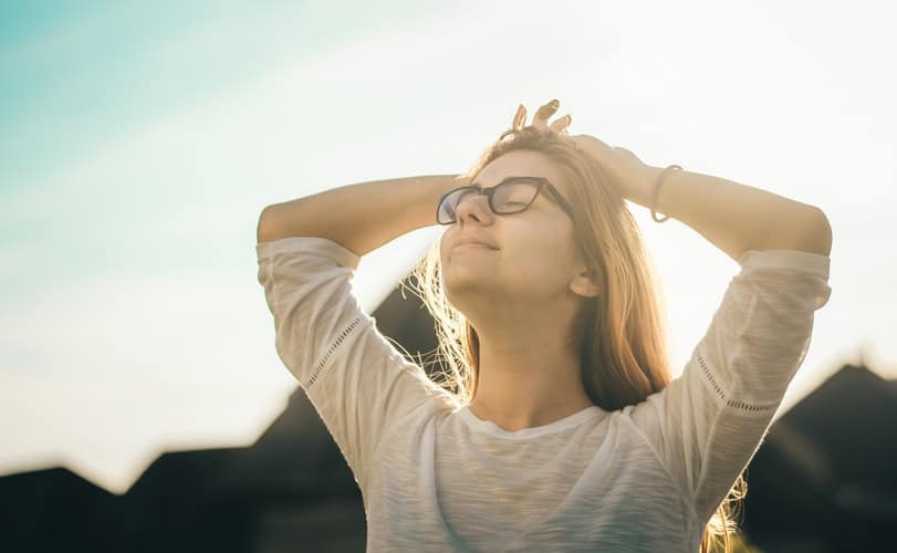 Woman breathing in outdoors.