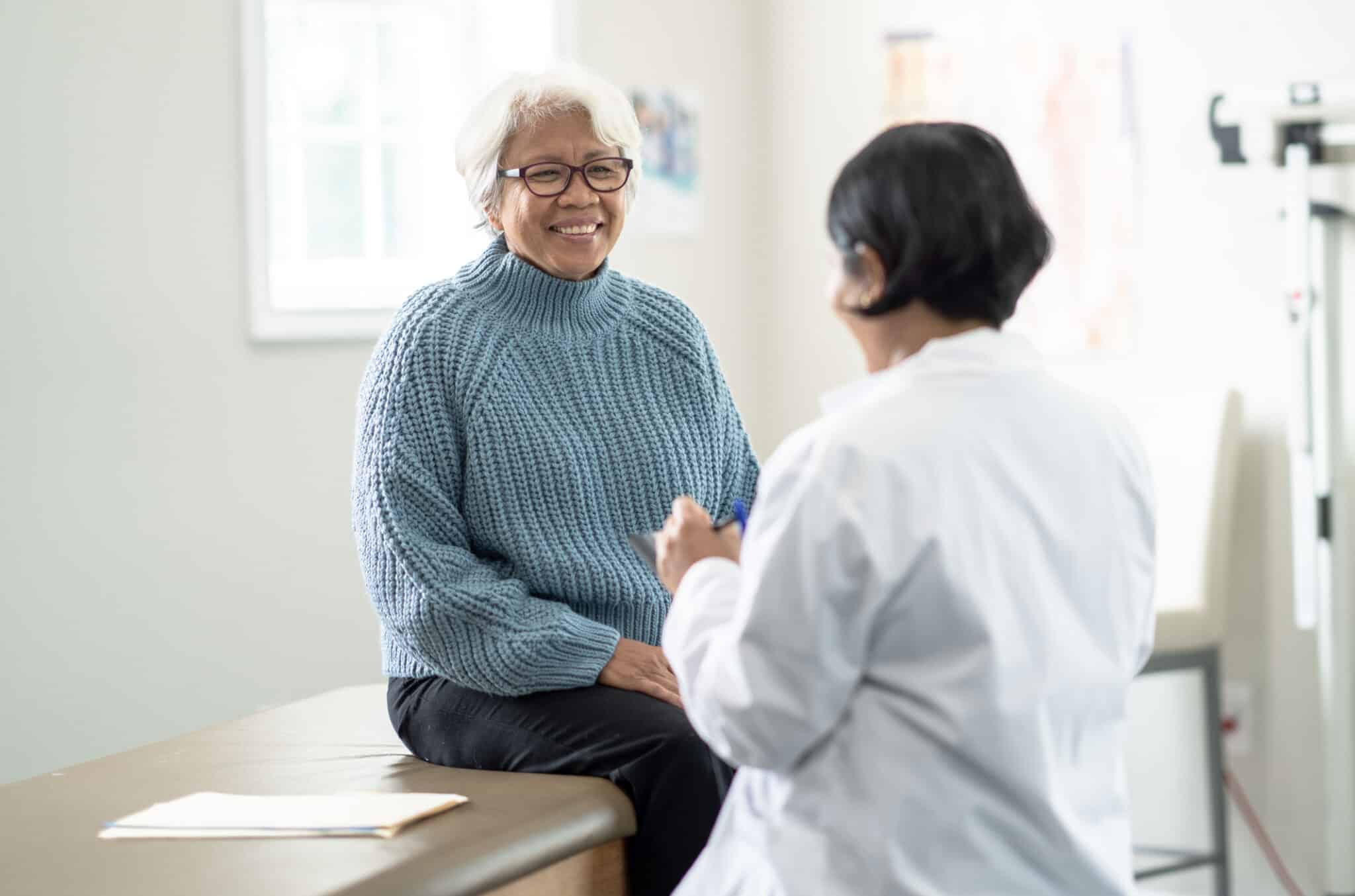 A woman speaking with an allergist at the office.