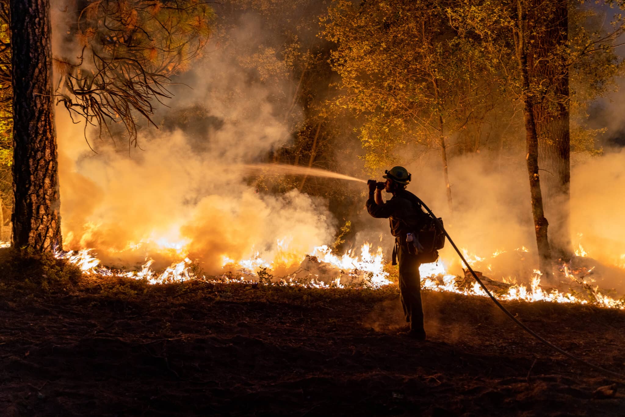 Firefighters battleing fire as Flames approaching Highway 50 during Caldor Fire in California