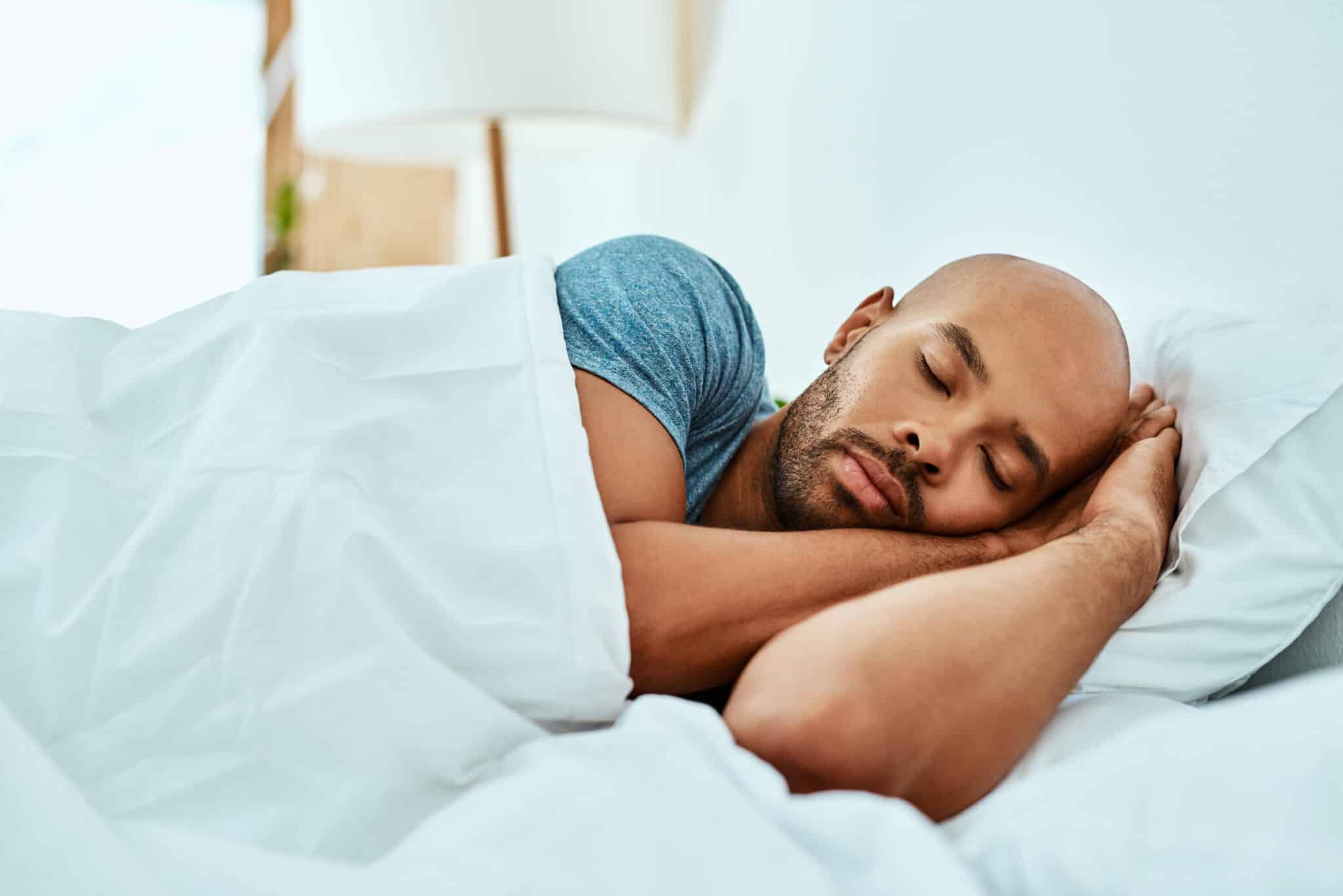 Man sleeping peacefully in bed.