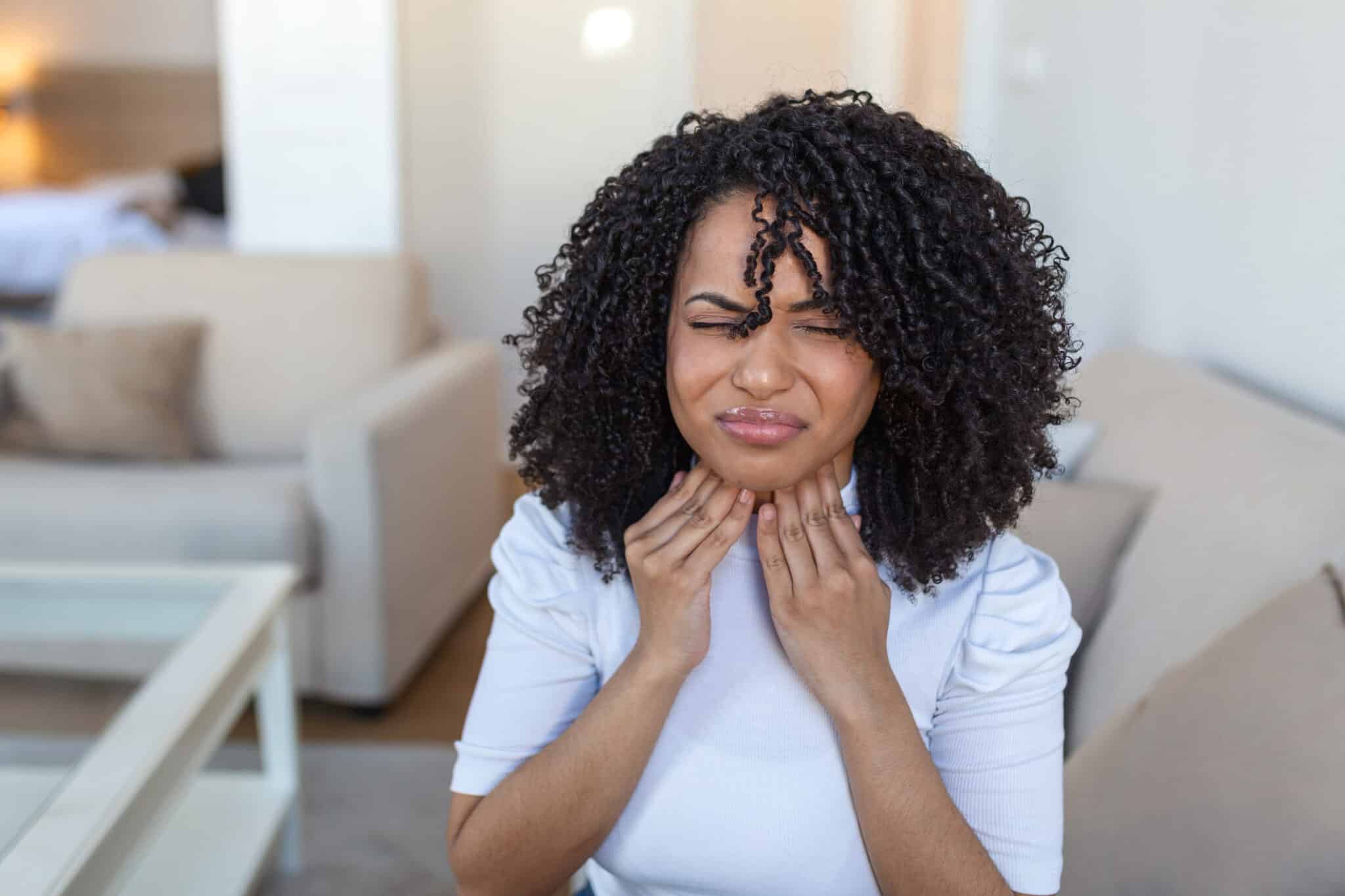 Close up of a woman with a sore throat and laryngitis.